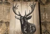 Rustic deer artwork on wood