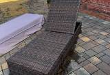 two wicker lounge chairs with covers
